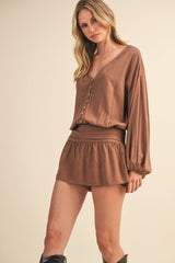 IR2396 LINEN LONGSLEEVE BUTTON AND SMOCKED WAIST ROMPER: Black / S