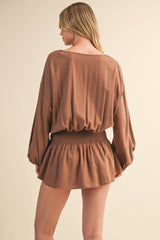 IR2396 LINEN LONGSLEEVE BUTTON AND SMOCKED WAIST ROMPER: Black / S