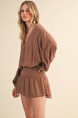 IR2396 LINEN LONGSLEEVE BUTTON AND SMOCKED WAIST ROMPER: Black / S