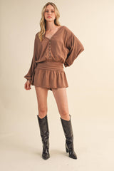 IR2396 LINEN LONGSLEEVE BUTTON AND SMOCKED WAIST ROMPER: Black / S