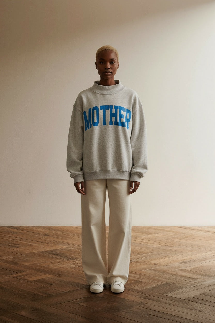 Full body view of the model wearing 'Mother & Cool Mom' Print Reversible Mock Neck