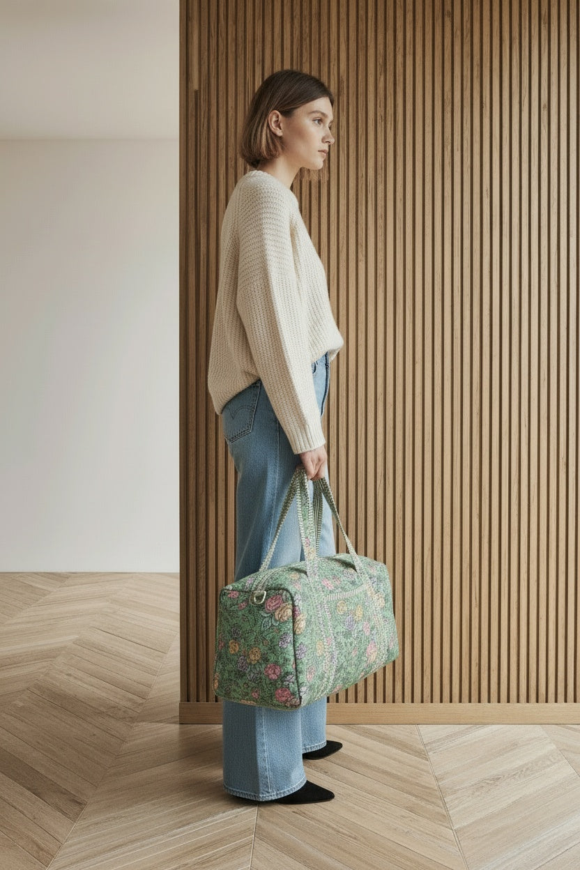 Side profile of the model wearing Handmade Quilted Cotton Duffle Bag, Block Printed Floral Weekender